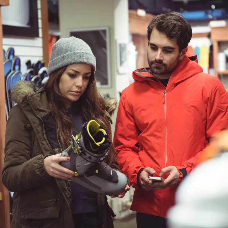 Customer trying on Hoka running shoes at a sports store